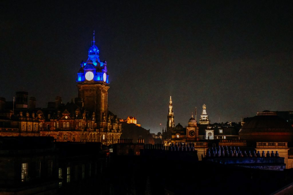Night time looking at the cityscape of Edinburgh, Scotland, including the Balmoral and Edinburgh Castle