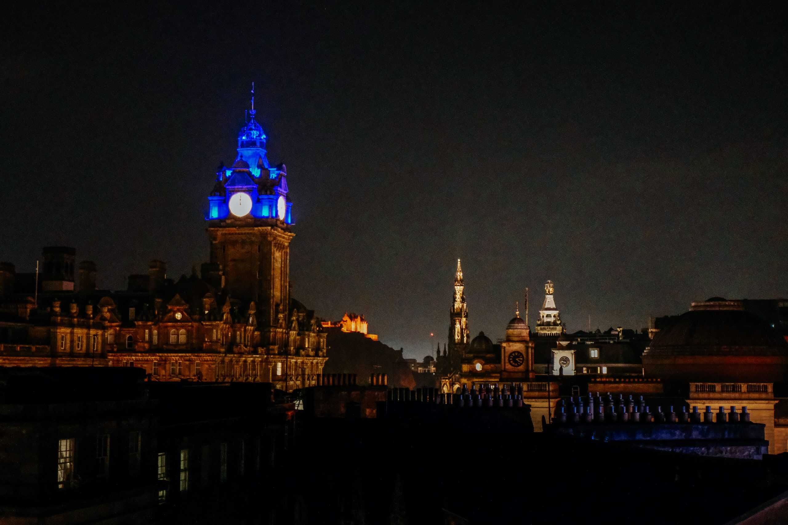 Night time looking at the cityscape of Edinburgh, Scotland, including the Balmoral and Edinburgh Castle