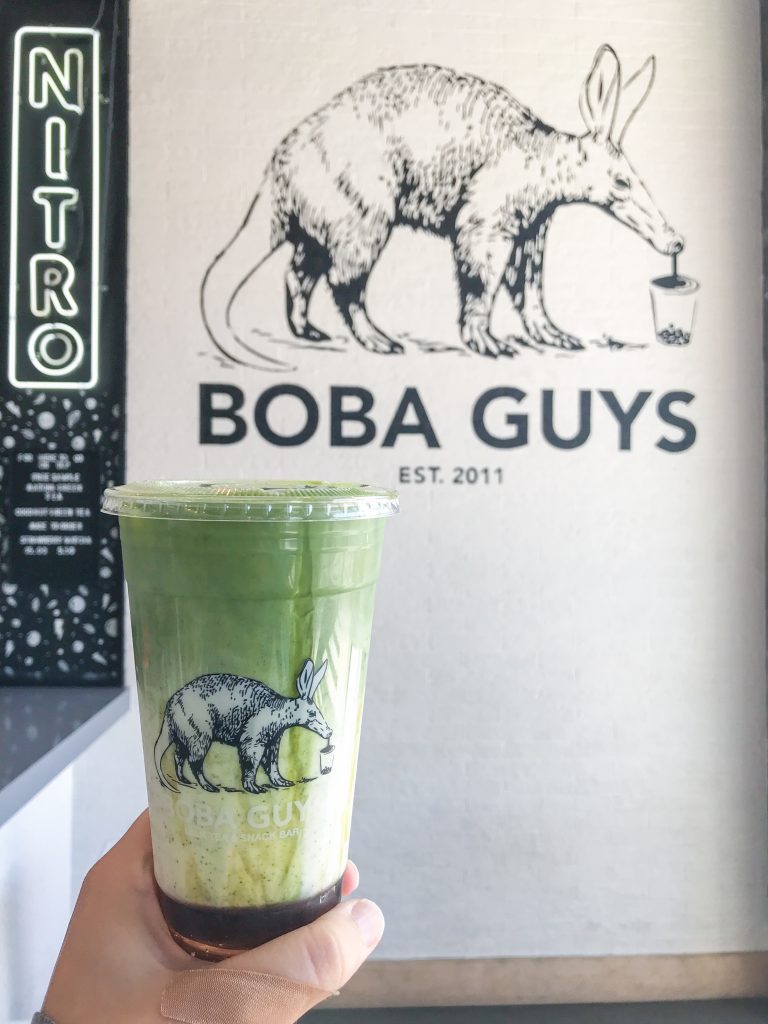 A matcha latte in front of the Boba Guys logo at the store in Potrero Hill in San Francisco