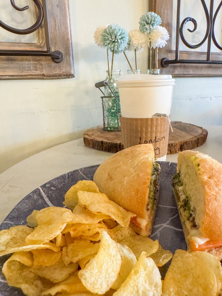 The Davinci sandwich with tomato, mozzarella, and pesto served with chips along with a London Fog tea at Pure Imagination Cafe in Rochester, NY