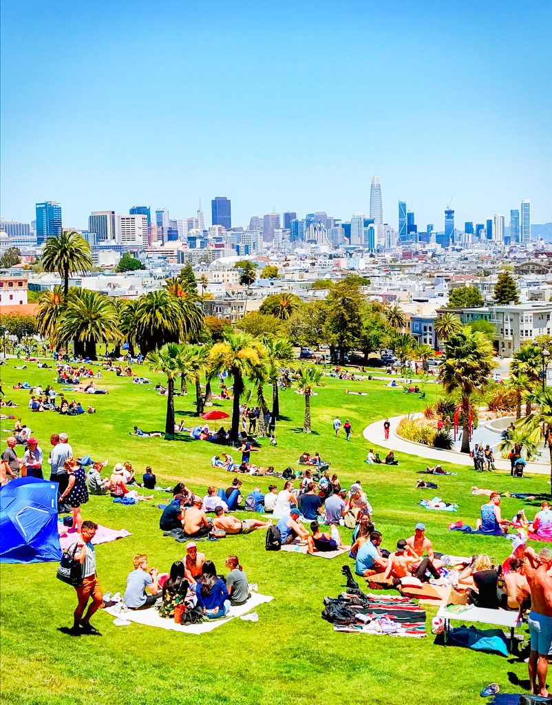 View of San Francisco from the mission district with a lot of people enjoying the park